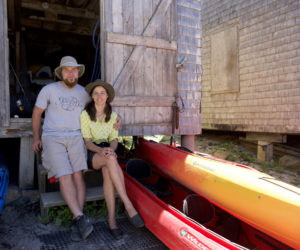Tristan and Ola Vis, managers of Monhegan Kayak Rentals, sit on the steps of the shop Friday, June 22. (Jessica Picard photo)