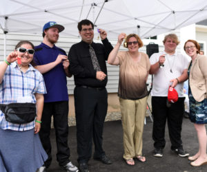 The first tenants of the Chandler House hold up their apartment keys during the grand opening Wednesday, June 27. (Jessica Picard photo)