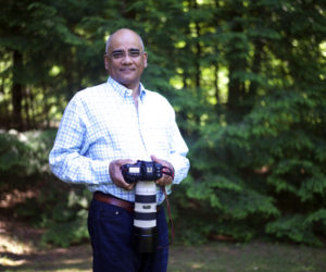 Dr. Rifat Zaidi poses with his camera in Newcastle, Thursday, July 5. (Jessica Picard photo)