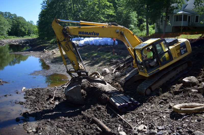 An excavator removes the remnants of a carriage road at the Coopers Mills Dam site Thursday, July 19. The contractor will remove the dam soon. (Jessica Clifford photo)