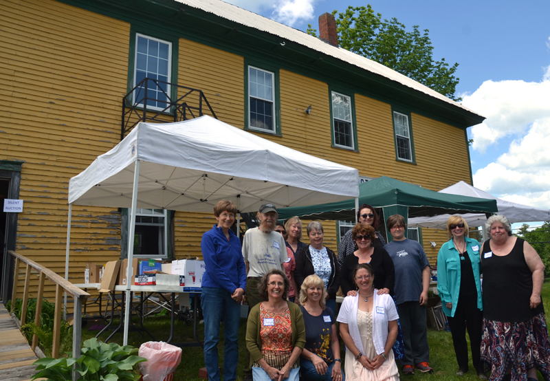 Whitefield Library volunteers stand in front of the Arlington Grange, which houses the library, during an open house June 9. The volunteers are researching the possibility of buying the hall. (Maia Zewert photo, LCN file)