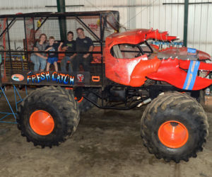 Cristy, Nathan, Zachary, and Greg Winchenbach sit in the cage of The Fresh Catch, the newest addition to the fleet at Bottom Feeder Motor Sports in Jefferson. The Fresh Catch is a ride truck, which gives passengers the thrill of riding in a monster truck. (Paula Roberts photo)