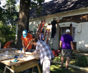 A 2017 Community Cares Day work crew repairs a house built in the 1800s.