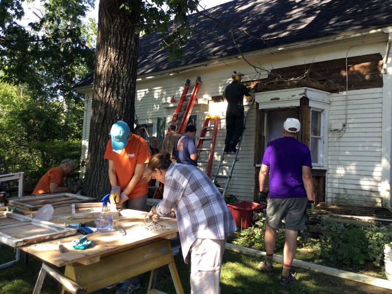 A 2017 Community Cares Day work crew repairs a house built in the 1800s.