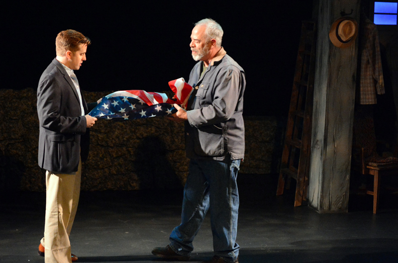 Michael Covel (left) and Peter Henderson fold the flag in "Independence Day," one of 14 vignettes in Heartwood Regional Theater Company's "Down Along the Cove." (Photo courtesy Jenny Mayher)