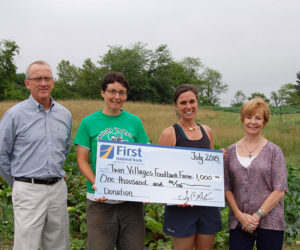 Gathered at the farm for a check presentation are (from left) Tony McKim, president and CEO of First National Bank; Sara Cawthon, farm manager at Twin Villages Foodbank Farm; Megan Taft, farm development at Twin Villages Foodbank Farm; and Susan Norton, eecutive vice president and chief administrative officer at First National Bank.