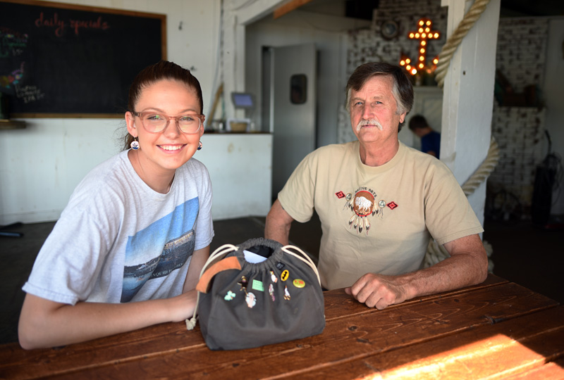 McKinley Neuser sits at The Contented Sole with Carl Reilly Sr., who found and returned her purse after it fell off of her scooter Monday, July 30. (Jessica Picard photo)