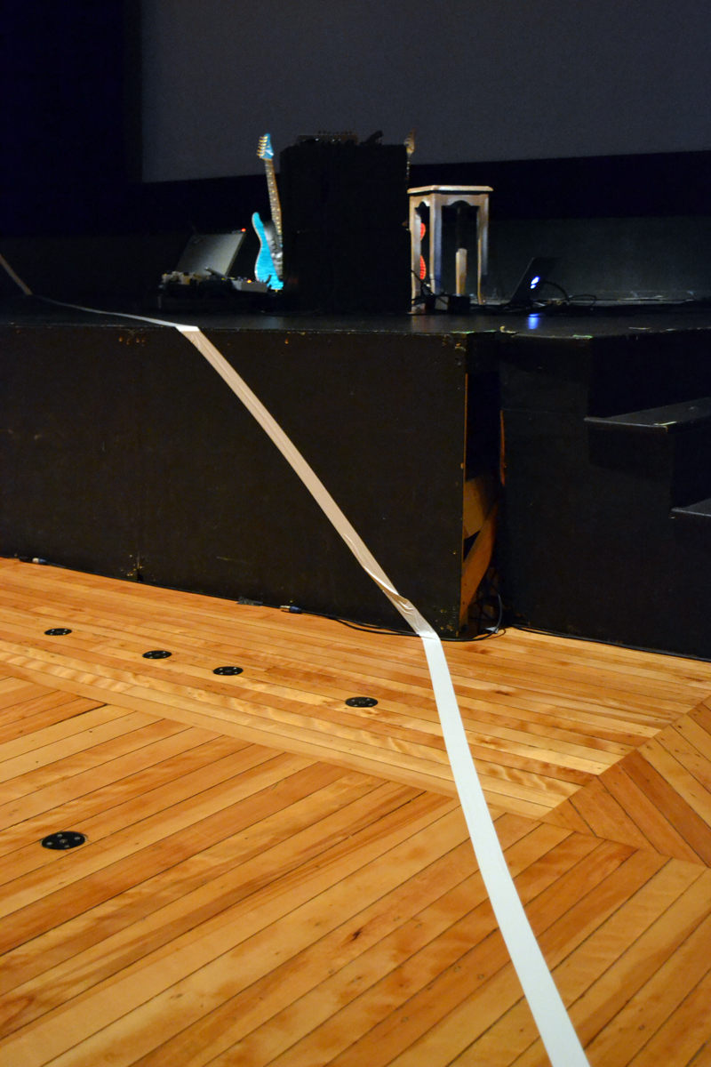 A boundary line made of wide white tape separating avant-garde musician-composer Steven Mackey from his audience echoes the white boundary line featured repeatedly in the film portion of his multimedia presentation of "Orpheus Unsung" at Lincoln Theater. (Christine LaPado-Breglia photo)