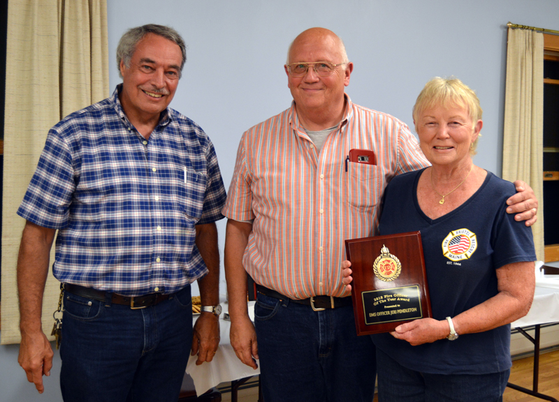 From left: Lincoln County Fire Chiefs Association Vice President Roger Whitney and Bristol Fire Chief Paul Leeman Jr. present the association's Officer of the Year Award to Jeri Pendleton, longtime leader of the Bristol First Responders.