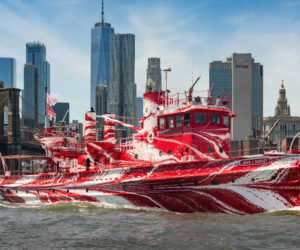 The John J. Harvey with the New York City skyline in the background. A seasonal resident of South Bristol owns the historic fireboat. Its temporary paint job mimics the "dazzle" camouflage of World War I. (Photo courtesy Public Art Fund)