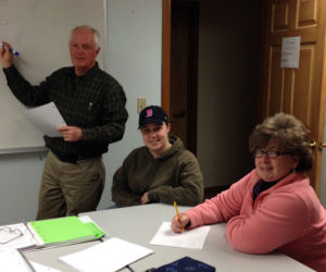 A college prep math class being taught by College Transitions math instructor Ron Carey (left).