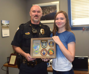 Sgt. Craig Worster receives a gift from incoming Wiscasset Middle High School freshman Alyssa Small. The student made the gift to thank Worster for helping her when she was being bullied. (Jessica Clifford photo)