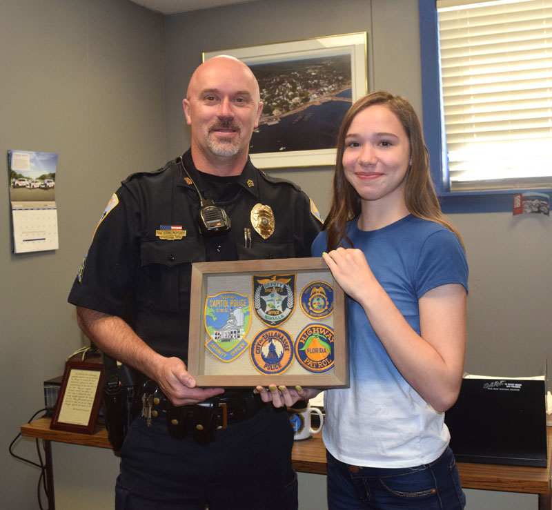 Sgt. Craig Worster receives a gift from incoming Wiscasset Middle High School freshman Alyssa Small. The student made the gift to thank Worster for helping her when she was being bullied. (Jessica Clifford photo)