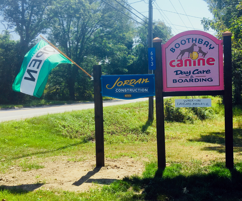 The pretty pink sign for Boothbay Canine Day Care & Boarding on Route 27. (Suzi Thayer photo)