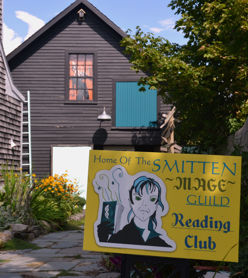 The sign for the Smitten Mage Guild book club outside Smitten Collectibles and Nerdy Treasures, at 2 Hodgdon St. in Damariscotta. (Maia Zewert photo)