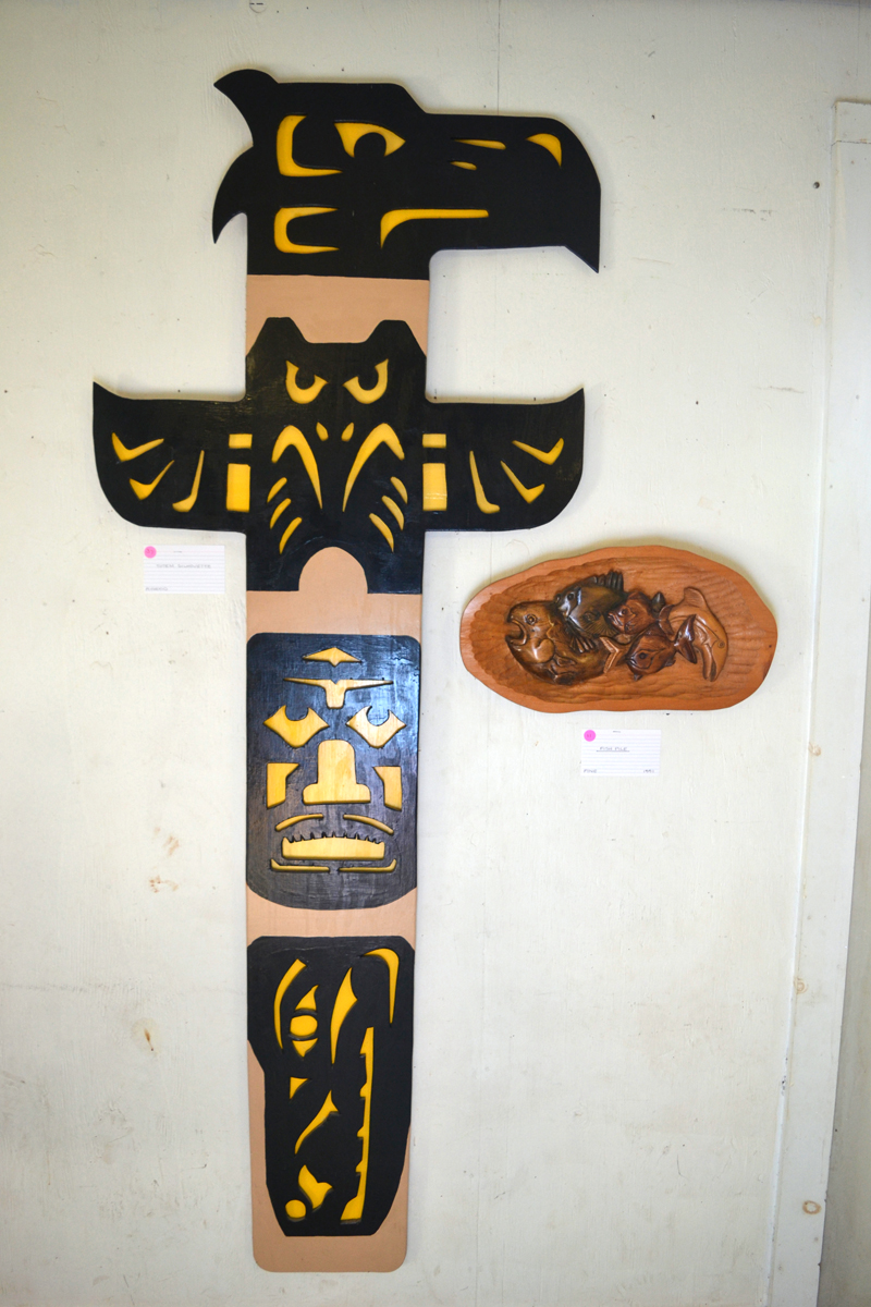 C. Thomas Sweet's "Totem Silhouette" hangs alongside his carving called "Fish Pile" in his current exhibit at Sheepscot General in Whitefield. (Christine LaPado-Breglia photo)