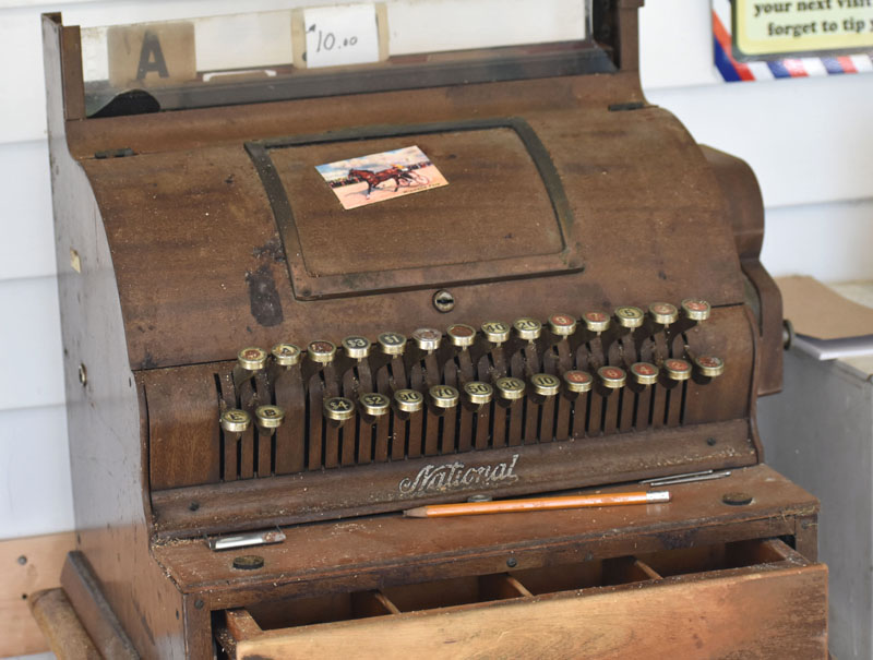 Bruce Soule brought an antique cash register from his downtown Damariscotta barbershop to his new shop in Waldoboro. (Alexander Violo photo)