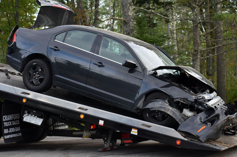 A Ford sedan is removed from the scene of a three-vehicle collision on Route 1 in Waldoboro on Wednesday, Sept. 12. (Alexander Violo photo)