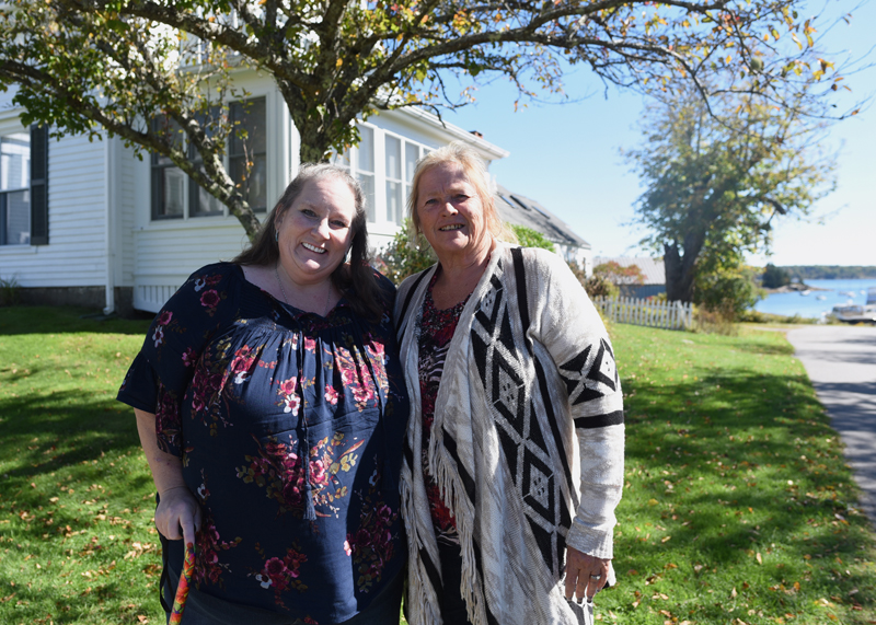 Carolyn Mattern (left) and Liz Michaud stand in front of what was once their great-grandparents' home in Round Pond on Oct. 5. (Jessica Picard photo)