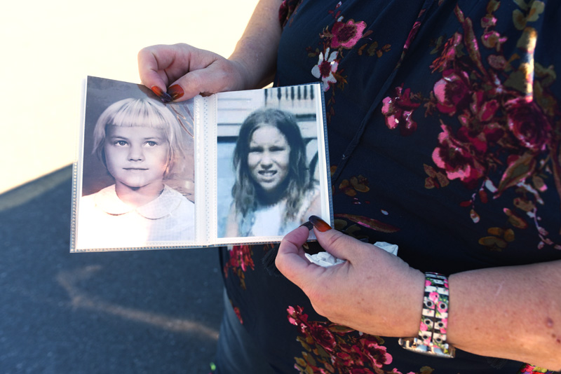 Carolyn Mattern holds photos of her sister, Liz Michaud, left, and herself as children. (Jessica Picard photo)