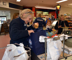 Carol Simmons places a jar of peanut butter in a reusable bag at Main Street Grocery in Damariscotta on Friday, Oct. 12. The store is introducing a new program to encourage the use of alternatives to plastic bags.