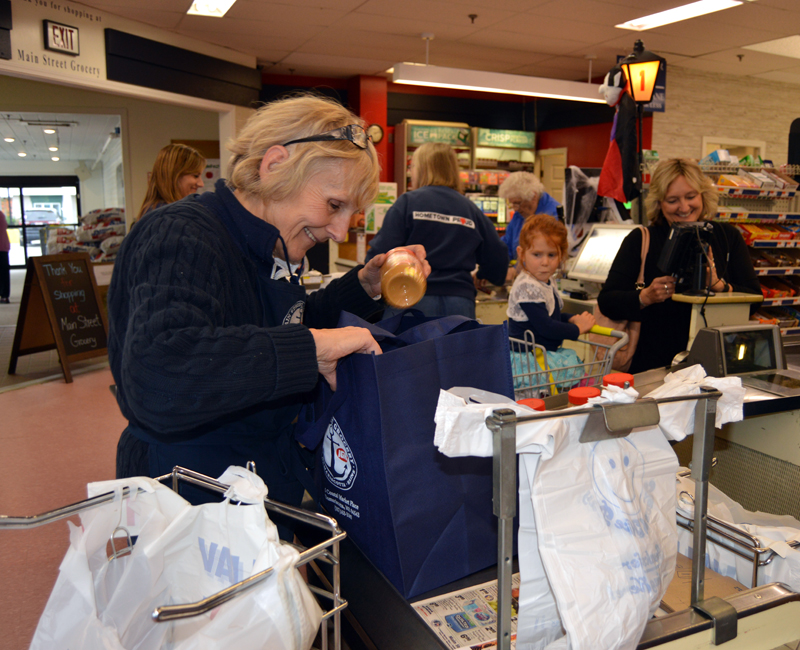 Carol Simmons places a jar of peanut butter in a reusable bag at Main Street Grocery in Damariscotta on Friday, Oct. 12. The store is introducing a new program to encourage the use of alternatives to plastic bags.