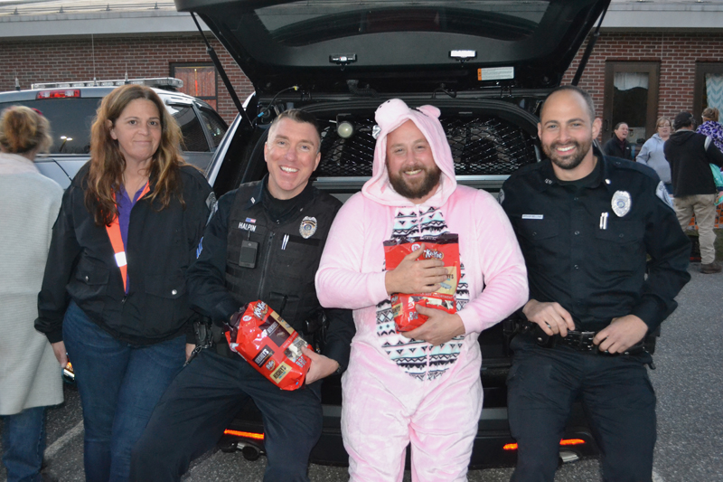 From left: Damariscotta Police Department Administrative Assistant Joanna Kenefick, Sgt. Erick Halpin, Chief Jason Warlick, and Officer David Bellows attend the Damariscotta Trunk-or-Treat at Great Salt Bay Community School on Oct. 31, 2017. (Maia Zewert photo, LCN file)