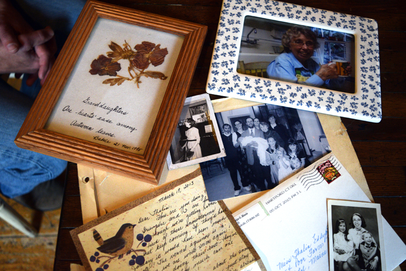 Family photos of Carolyn Blouin, with a gift and a postcard from Blouin, at her son and daughter-in-law's home in Bristol. (Jessica Clifford photo)