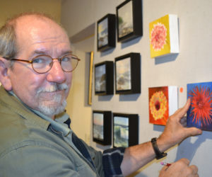 Will Kefauver, who heads up Kefauver Studio & Gallery in Damariscotta, hangs pieces in the new "6 x 6" show on Thursday, Oct. 11. (Christine LaPado-Breglia photo)