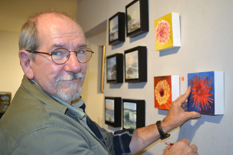 Will Kefauver, who heads up Kefauver Studio & Gallery in Damariscotta, hangs pieces in the new "6 x 6" show on Thursday, Oct. 11. (Christine LaPado-Breglia photo)