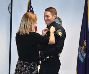 Sara Lash pins the badge on her husband, new Waldoboro Police Chief John Lash. (Alexander Violo photo)