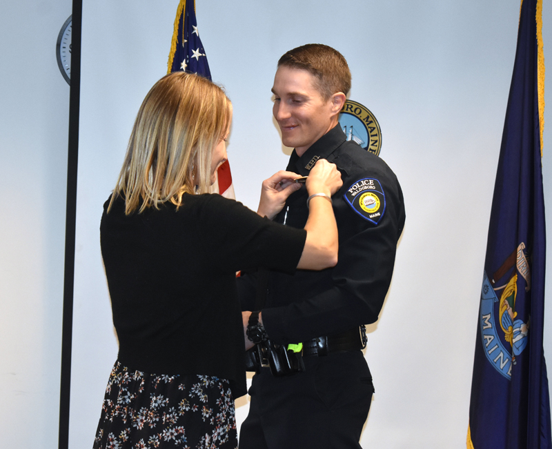 Sara Lash pins the badge on her husband, new Waldoboro Police Chief John Lash. (Alexander Violo photo)