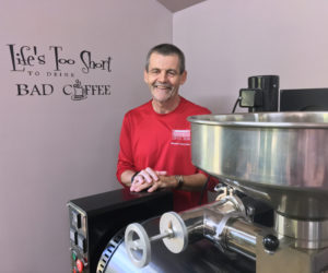 Steve Arsenault at his coffee-roasting business, Crossroads Coffee Beans, on Westport Island. The writing on the wall says "Life's too short to drink bad coffee." (Suzi Thayer photo)