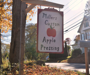 The sign for Miller's Custom Apple Pressing on Route 218, next to the North Whitefield Superette. (Jessica Clifford photo)