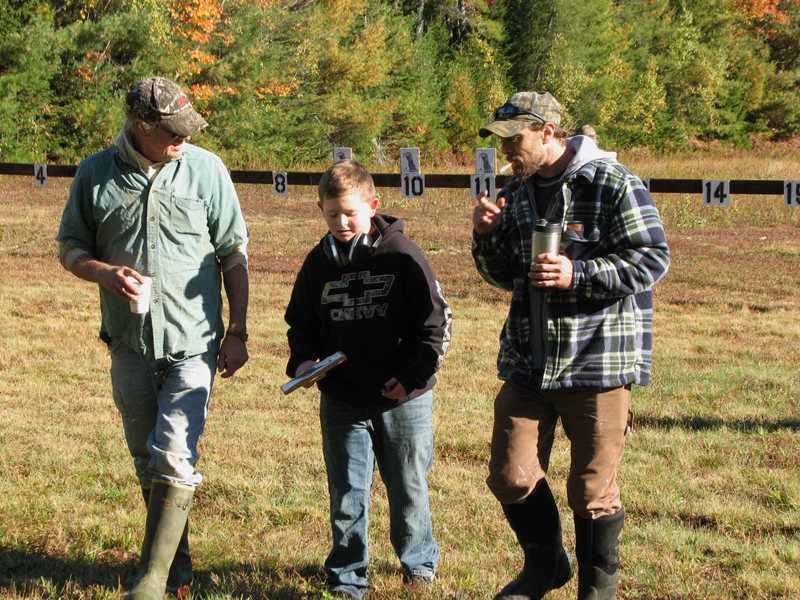 From left: David, Landon, and Derek Hanna walk back from retrieving targets.