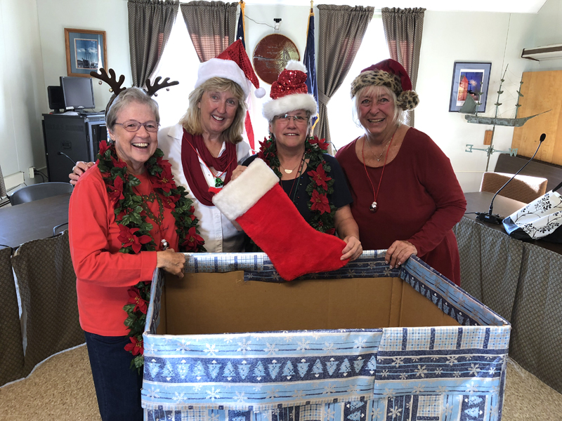 From left: Wiscasset community members Nancy Roby, Terri Wells, Judy Flanagan, and Terry Hellerbegin work on providing help to parents in providing the needs and wishes of local children during this holiday season by promoting the Annual Spirit of Giving program. (Photo courtesy Kathy Onorato, Town of Wiscasset)