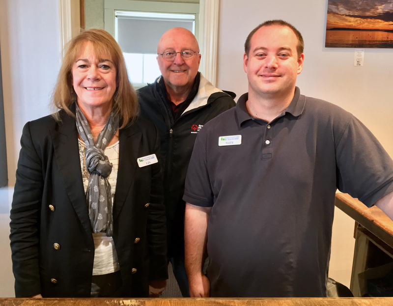 From left: desk clerk Lin Koch, co-owner Tony Krason, and office manager Nate Stanley at the front desk of the Ocean Point Inn. (Suzi Thayer photo)