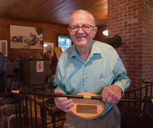 Albert Boynton holds a replica of Whitefield's Boston Post Cane. Boynton, 92, holds the cane as the town's oldest resident. (Jessica Clifford photo)