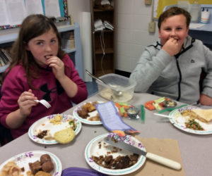 Emily Tibbetts and Gaven Young, sixth-graders at Nobleboro Central School, try hummus and veggies.