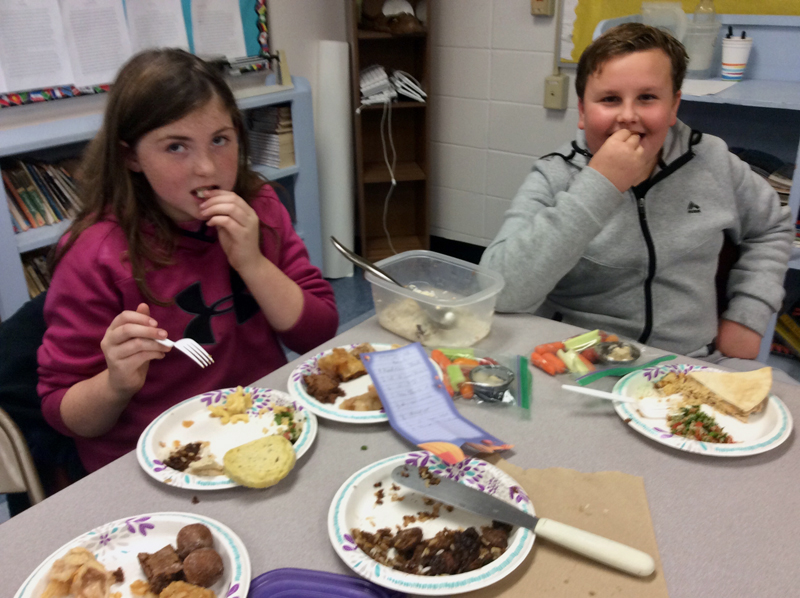 Emily Tibbetts and Gaven Young, sixth-graders at Nobleboro Central School, try hummus and veggies.
