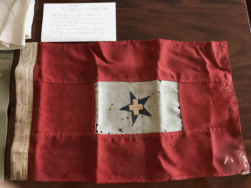 During World War I, families would hang banners like this one in a window of their home when a family member was in the service. The star with the cross means the service member was wounded. (Photo courtesy Mary Ann Chase Vinton)