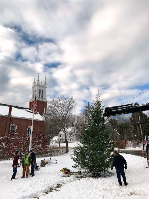 Volunteers help put up a large Christmas tree in Veterans Memorial Park in Newcastle on Saturday, Nov. 17.