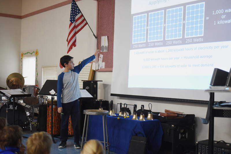 Bristol Consolidated School sixth-grader Joshua Arzate points to a slide during a presentation on solar energy to younger students Thursday, Nov. 29. (Jessica Picard photo)