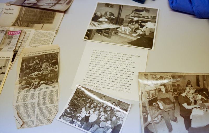 Old newspaper clippings and photos tell the story of People to People, which is celebrating its 50th anniversary this year. At bottom right is an undated photo of Shirley Tibbetts, who now runs the service. (Jessica Picard photo)