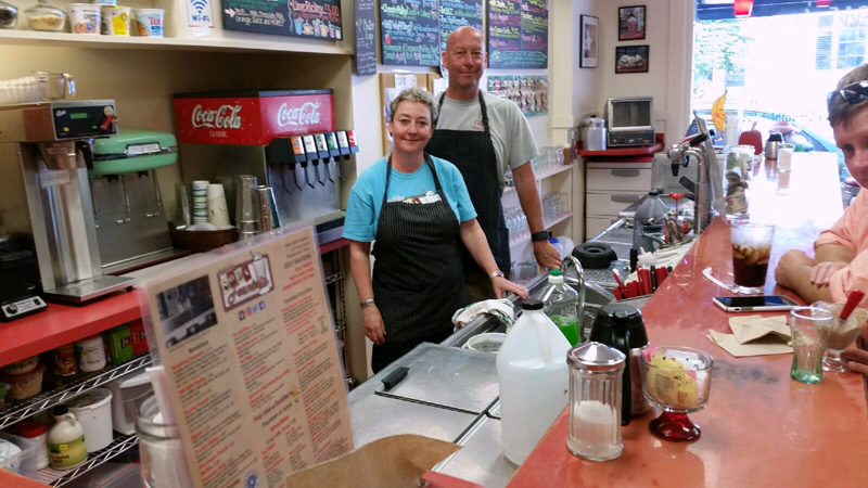 Christie and Dean Jacobs behind the counter at Waltz Soda Fountain. The third generation of their family to own the business, they worked at the soda fountain as kids. (Photo courtesy Waltz Soda Fountain)