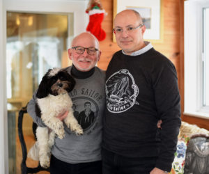 Danny Cain and Don Bostick, owners of Hello Sailor TMH, pose with their dog, Millie, at their home in Newcastle Monday, Dec. 17. (Jessica Picard photo)