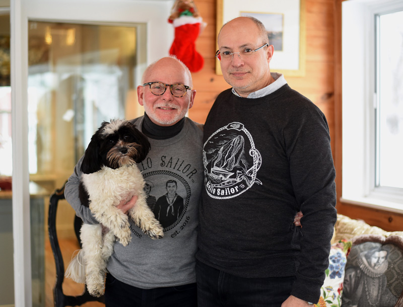 Danny Cain and Don Bostick, owners of Hello Sailor TMH, pose with their dog, Millie, at their home in Newcastle Monday, Dec. 17. (Jessica Picard photo)