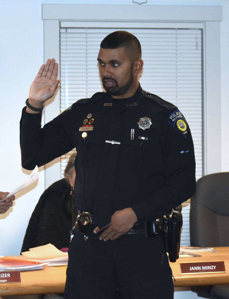 Officer Nathaniel Jack, of the Waldoboro Police Department, takes the oath of office during a ceremony at the municipal building Dec. 11. (Alexander Violo photo)