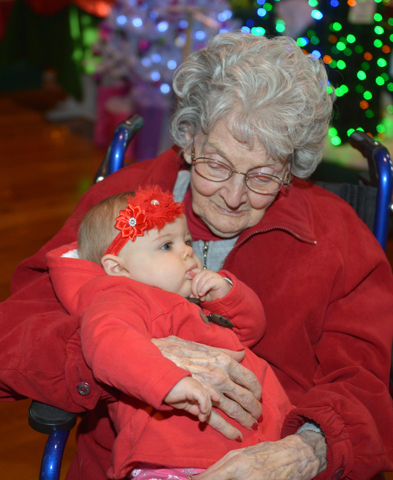 St. Andrews Village resident Louise Greene holds 8-month-old McKayla Taylor at the Festival of Trees at the Boothbay Harbor Opera House. (Paula Roberts photo)