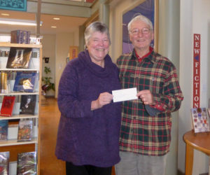 Skidompha Library Executive Director Pam Gormley receives a check for renewal of a museum pass to the Portland Museum of Art from Paul Sherman, vice president of the Pemaquid Group of Artists.